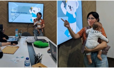 working mum carrying baby in meeting