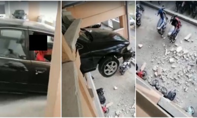 car crash hang from building